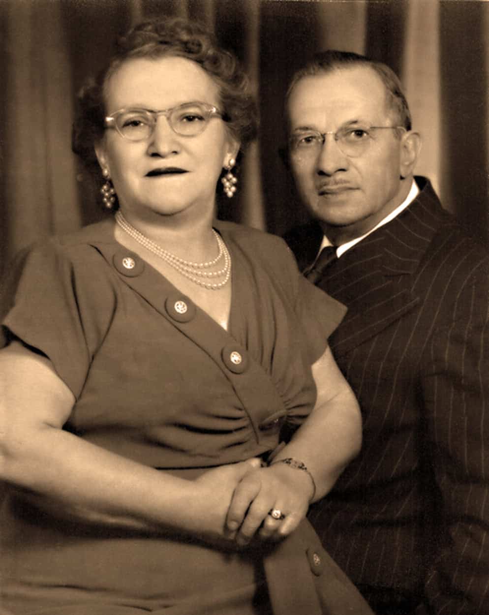Vintage photo of a woman and man in formal attire.