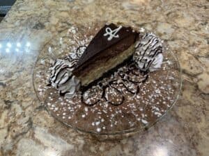 Chocolate cake with rich frosting and decorative toppings.