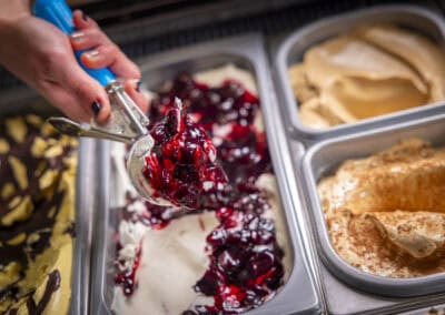 Freshly scooped ice cream with berry topping at Angelo's Restaurant. Ice cream with berry topping, served at Angelo's Restaurant.