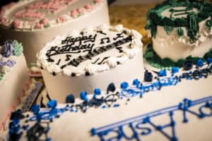 Decorative birthday cakes with musical notes and vibrant colors.