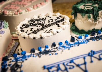 Celebration Cakes at Angelo's Restaurant Decorative birthday cakes with musical notes and vibrant colors.
