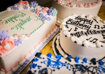 Celebration Cakes at Angelo's Restaurant Delicious birthday cakes with colorful frosting and musical notes, perfect for special occasions at.