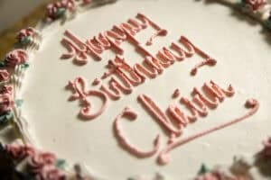Cake with "Happy Birthday" message in pink icing.