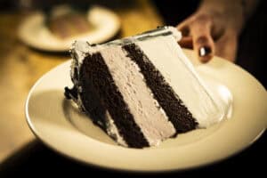 Delicious chocolate layer cake with creamy white frosting, perfect for celebrations at Angelo's Rest.
