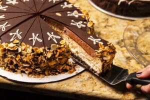 Chocolate cake with layers of rich frosting and toasted almond toppings. Perfect dessert for special.