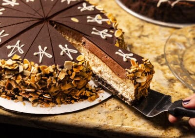 Delicious Chocolate Cake at Angelo's Restaurant Chocolate cake with layers of rich frosting and toasted almond toppings. Perfect dessert for special.