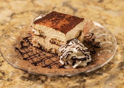 Chocolate Tiramisu Dessert Delicious chocolate tiramisu served with whipped cream and chocolate drizzle.