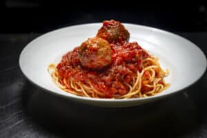 Classic spaghetti with meatballs in rich tomato sauce at Angelo's Restaurant.