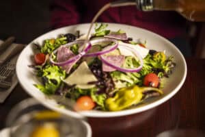 Colorful garden salad with fresh vegetables and mixed greens at Angelo's Restaurant.