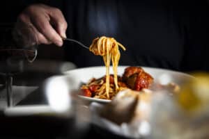 Delicious spaghetti with meatballs served at Angelo's Restaurant, showcasing authentic Italian cuisi.