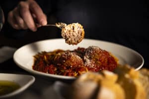 Delicious Italian meatball served over pasta at Angelo's Restaurant.