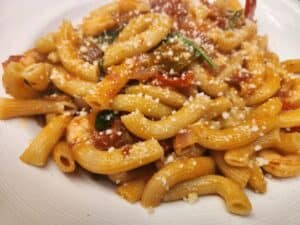 Delicious pasta dish featuring tomato sauce, fresh herbs, and grated Parmesan cheese. Perfect for a.