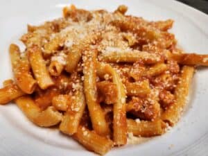 Delicious pasta with rich tomato sauce and grated cheese, served at Angelo's Restaurant.