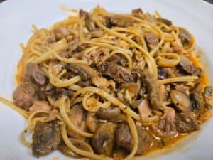 Beef and mushroom pasta dish served at Angelo's Restaurant. Delicious, hearty Italian cuisine with t.