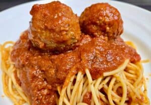 Spaghetti with homemade meatballs in rich tomato sauce, served at Angelo's Restaurant.