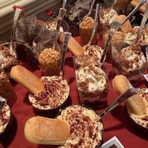 Assorted gelato desserts with toppings and cookies served in small cups. Perfect for a sweet treat a.