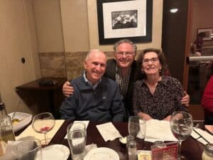 Happy guests enjoying a meal with friends in a cozy dining setting.