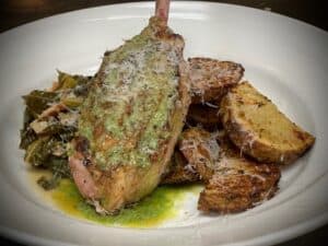 Delicious stuffed fish served with crispy roasted potatoes and sautéed greens, perfect for a flavorf.