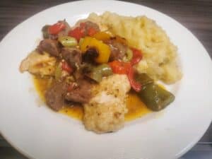 Hearty beef stew with colorful peppers served with mashed potatoes at Angelo's Restaurant.