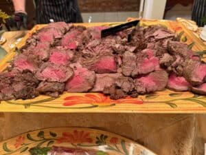 Delicious sliced grilled steak served on a wooden platter at Angelo's Restaurant. Perfect for steak.