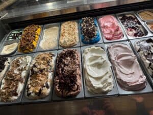 Assorted gelato flavors with toppings displayed at Angelo's Restaurant.