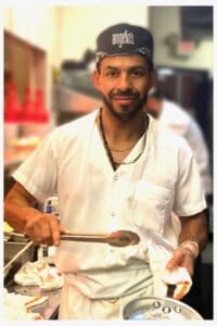 Chef preparing fresh pasta in the kitchen at Angelo's Restaurant.